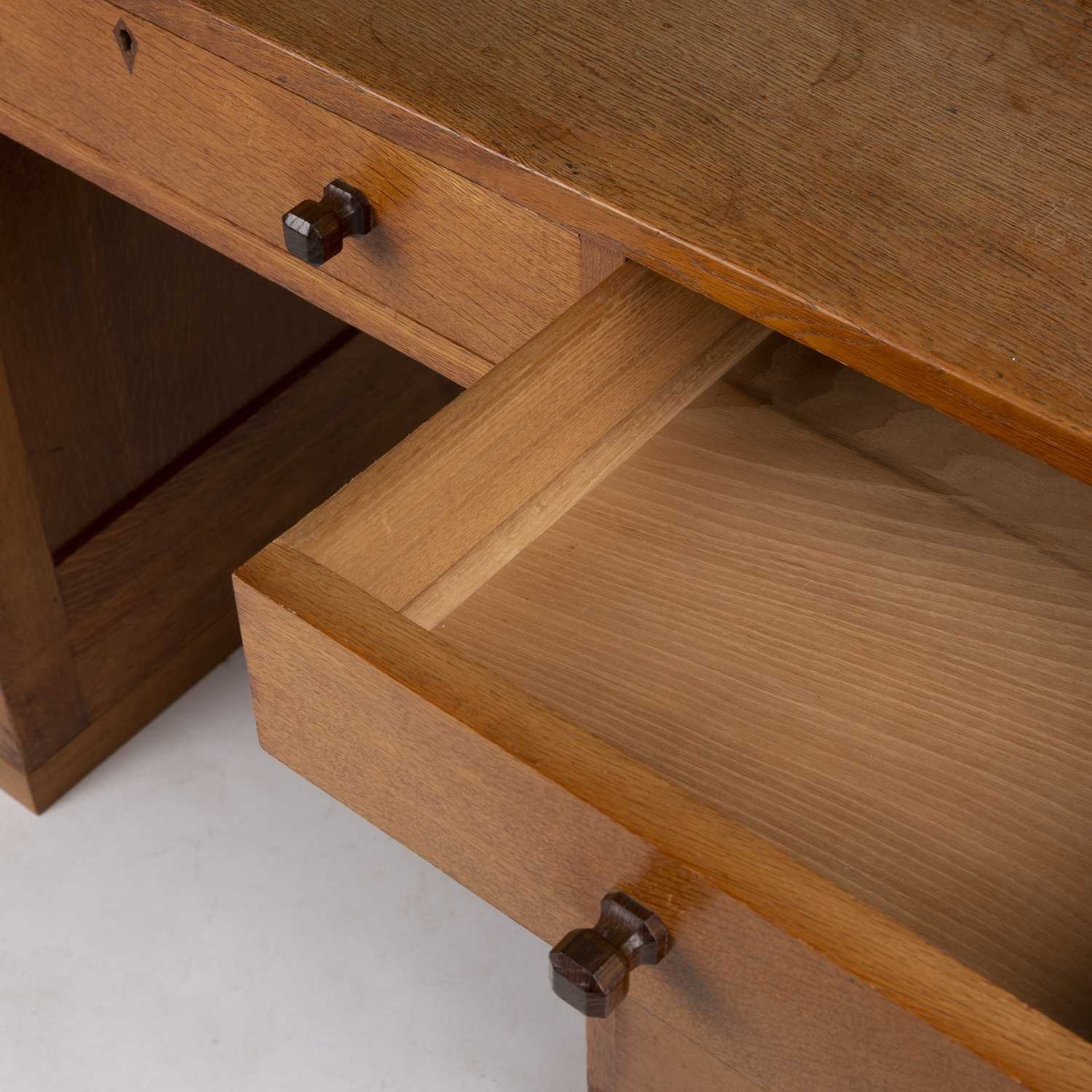 Gordon Russell (1892-1980) Desk, circa 1930 oak, with nine fitted drawers, each with carved - Image 5 of 5