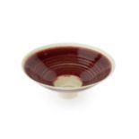 Peter Wills (b.1955) Footed bowl porcelain, with flared rim and red glaze with a light green rim