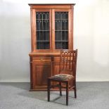 An Edwardian walnut cabinet bookcase