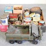 A military model truck and vintage advertising tins