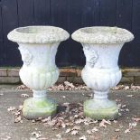 A pair of cast stone campana planters