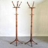 A pair of Edwardian walnut hat stands