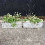 A pair of cast stone planters