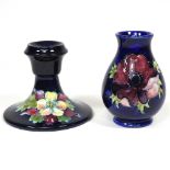 A Moorcroft pottery candlestick and vase