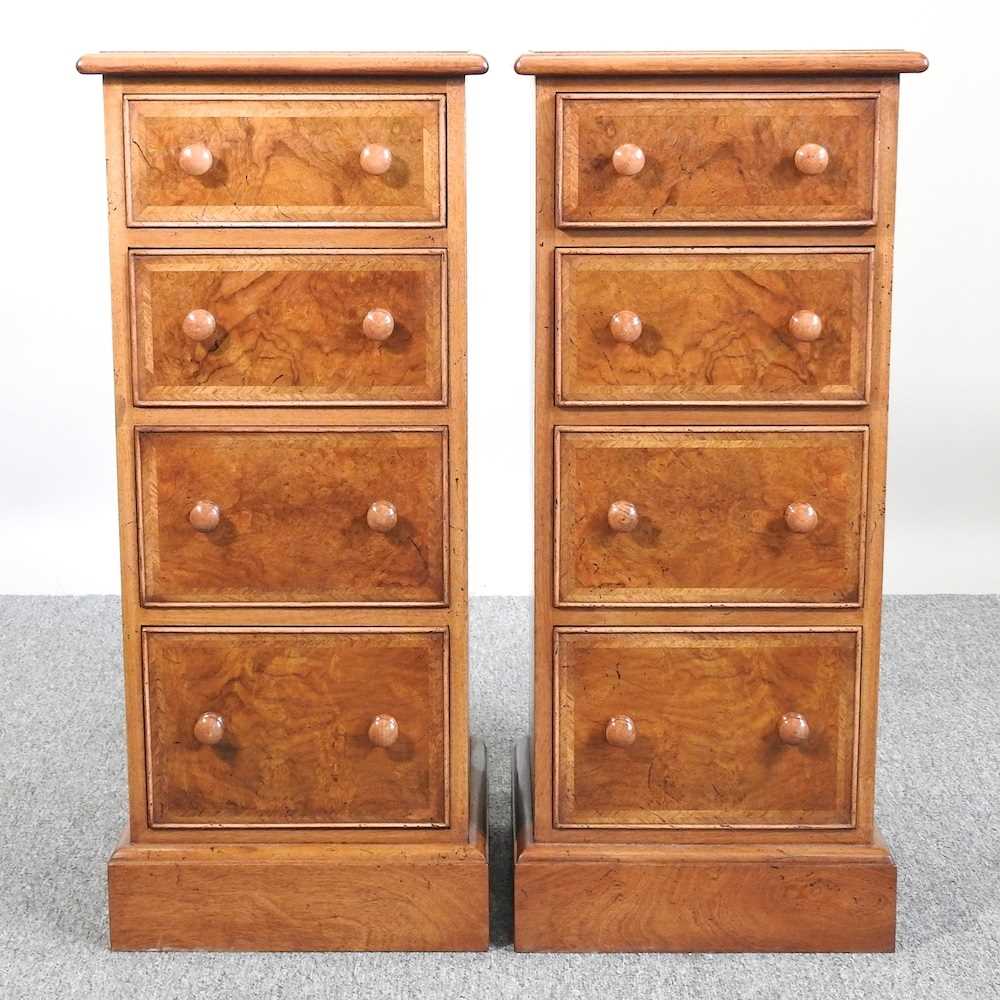 A pair of walnut bedside chests