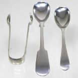 A silver spoon, another and a pair of sugar nips