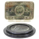 A reproduction tin and a coin