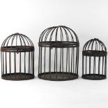 A set of three bird cages