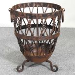 A wrought iron log basket