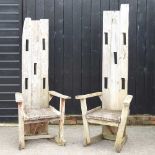 A pair of teak garden chairs