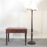 A Victorian writing table and lamp