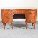 An Edwardian satinwood kidney shaped desk