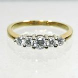 An 18 carat gold five stone diamond ring