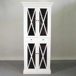 A white painted glazed standing bookcase