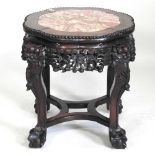 An early 20th century Chinese carved jardinière stand