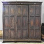 A Maple & Co oak triple wardrobe, with fitted interior