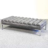 A modern grey upholstered footstool