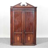 A George III mahogany and inlaid hanging corner cabinet