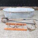 A large galvanised trough, with vintage tools