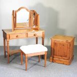 A pine dressing table, stool and bedside cabinet