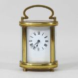 An early 20th century brass oval carriage clock