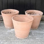 A set of three terracotta pots
