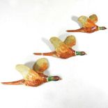 A set of three Beswick pottery graduated wall mounted flying pheasants