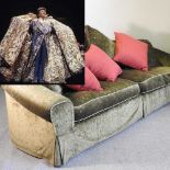 A large green sofa, formerly the property of Liberace