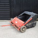 A tractor-towed lawn sweeper