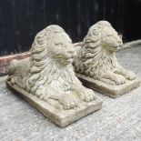 A large pair of cast stone garden lions