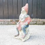 A cast stone garden gnome