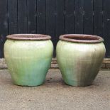 A large pair of olive glazed garden pots