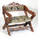 An early 20th century continental carved oak armchair