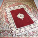 A Persian rug, together with another