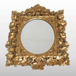 An ornate carved wood and gilt framed wall mirror