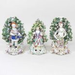 A pair of Derby porcelain figures, together with another