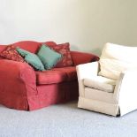 A red upholstered sofa and armchair