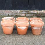 A set of six terracotta garden pots