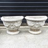 A pair of cast stone garden pots