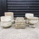 A collection of stone garden pots