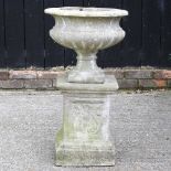 A cast stone garden urn