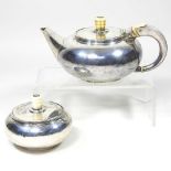 A silver teapot and sugar bowl