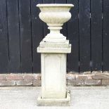 A cast stone garden urn