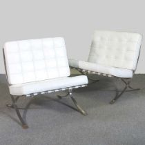 A pair of white Barcelona chairs
