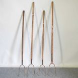 A collection of four pitchforks