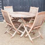 A teak folding garden table and chairs