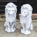 A pair of cast stone lions
