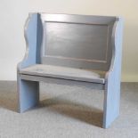 A grey painted pew