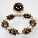 A gold and tiger's eye bracelet and brooch