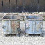 A pair of small cast iron planters